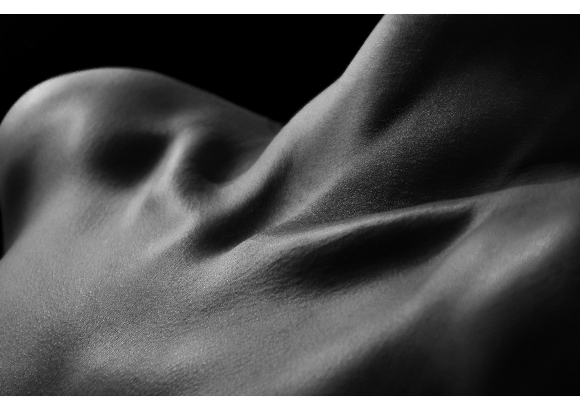 a black and white photo of a woman's chest. Sensual vibe
